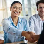 This Partnership Is Gonna Be Great. Cropped Shot Of Two Young Businesspeople Shaking Hands During A Meeting In The Boardroom.
