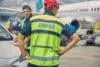 Airport Worker Standing Next To His Colleague