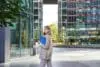 Corporate Woman In Business Suit, Walking In City Center With Work Papers And Mobile Phone, Calling Someone