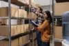 Warehouse Manager Coordinating Worker Picking Order In Storage Room