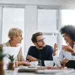 I Need Everyone To Give Me Their Best Ideas. Shot Of A Group Of Businesspeople Sitting Together In A Meeting.