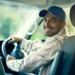 Portrait, Driver Or Delivery Man With Smile For Safety On Cargo, Stock Or Package In Van In Shipping Business. Parcel Order, Car Or Happy Courier Driving In Transportation For Supply Chain Or Freight