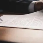 Hand Holding Pen Signing Contract In Important Documents.