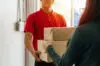 Delivery Service Man In Red Uniform With Young Man Customer Rece