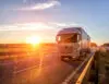 Modern Wagon Truck Transports Cargo Against The Backdrop Of A Sunset. The Concept Of Truck Drivers In The Field Of Freight And Logistics, Copy Space