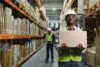 Portrait Of A Handsome African American Warehouse Worker In Overalls And A Helmet