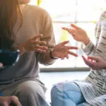 People Sitting And Talking Together