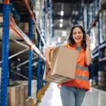 Warehouse Worker Using Headset Carrying Box
