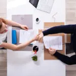 Businessman Shaking Hand With Female Applicant