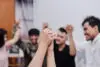 Symbolic Picture Showing That We Are Stronger Together. Two People Holding Hand And Raising In Unity.