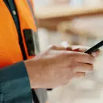 Social Media, Internet And Hands Of An Architect With A Phone For Communication, Construction Website And Building App. Construction Worker Working On A Mobile, Typing On Web And Doing Search On Site