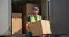 Delivery Worker Carrying Box From Truck