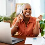 Phone Call, Laugh And Business Black Woman In Office For Contact, Connection And Network. Corporate, Communication And Happy Female Worker On Smartphone For Funny Conversation, Discussion And Chat
