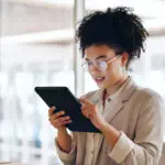 Tablet, Black Woman And Business Marketing, Social Media Update Or Networking With Smile. Website, Company Blog Or Online Communication, Office Worker With Glasses Smile For Digital Strategy Success