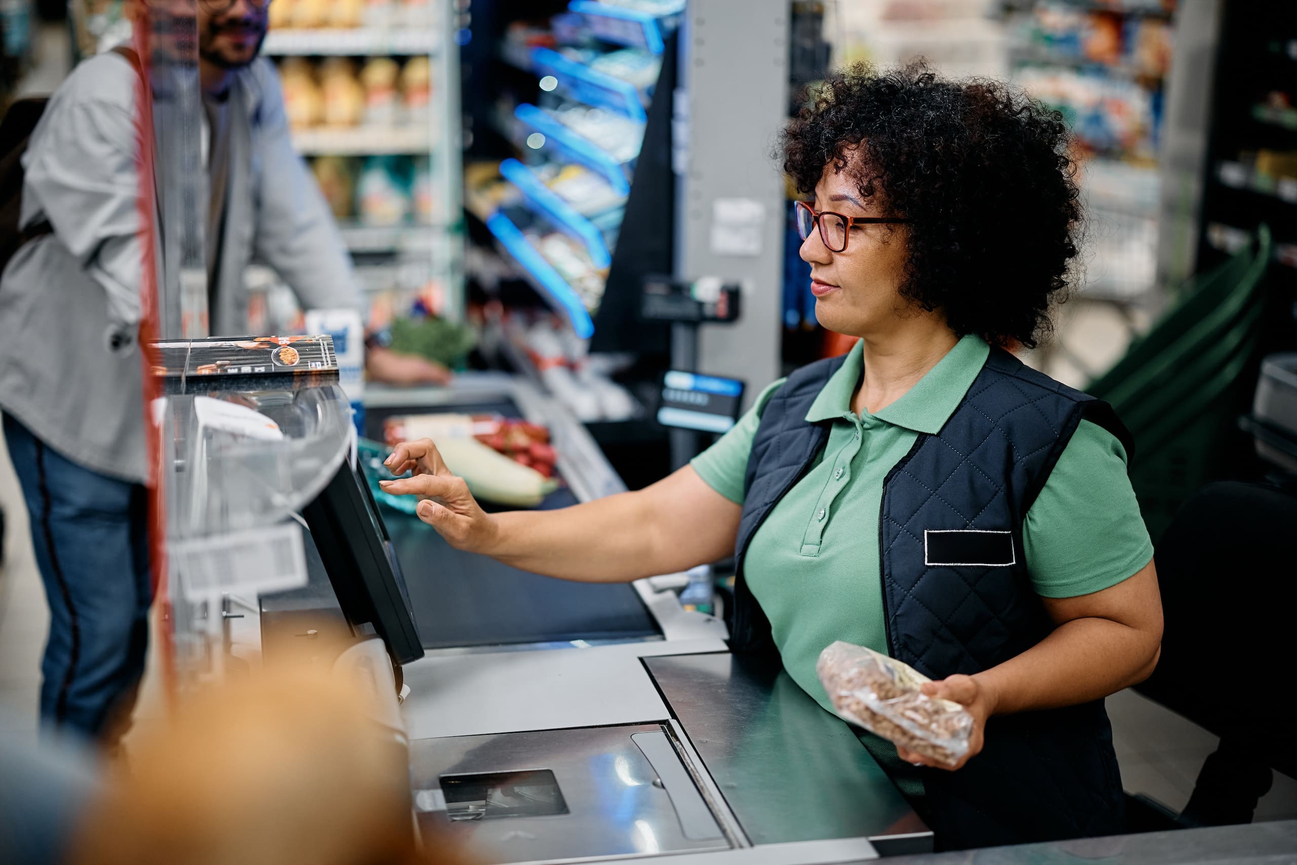 Mid Adult Woman Working As Cashier In The Supermarket.