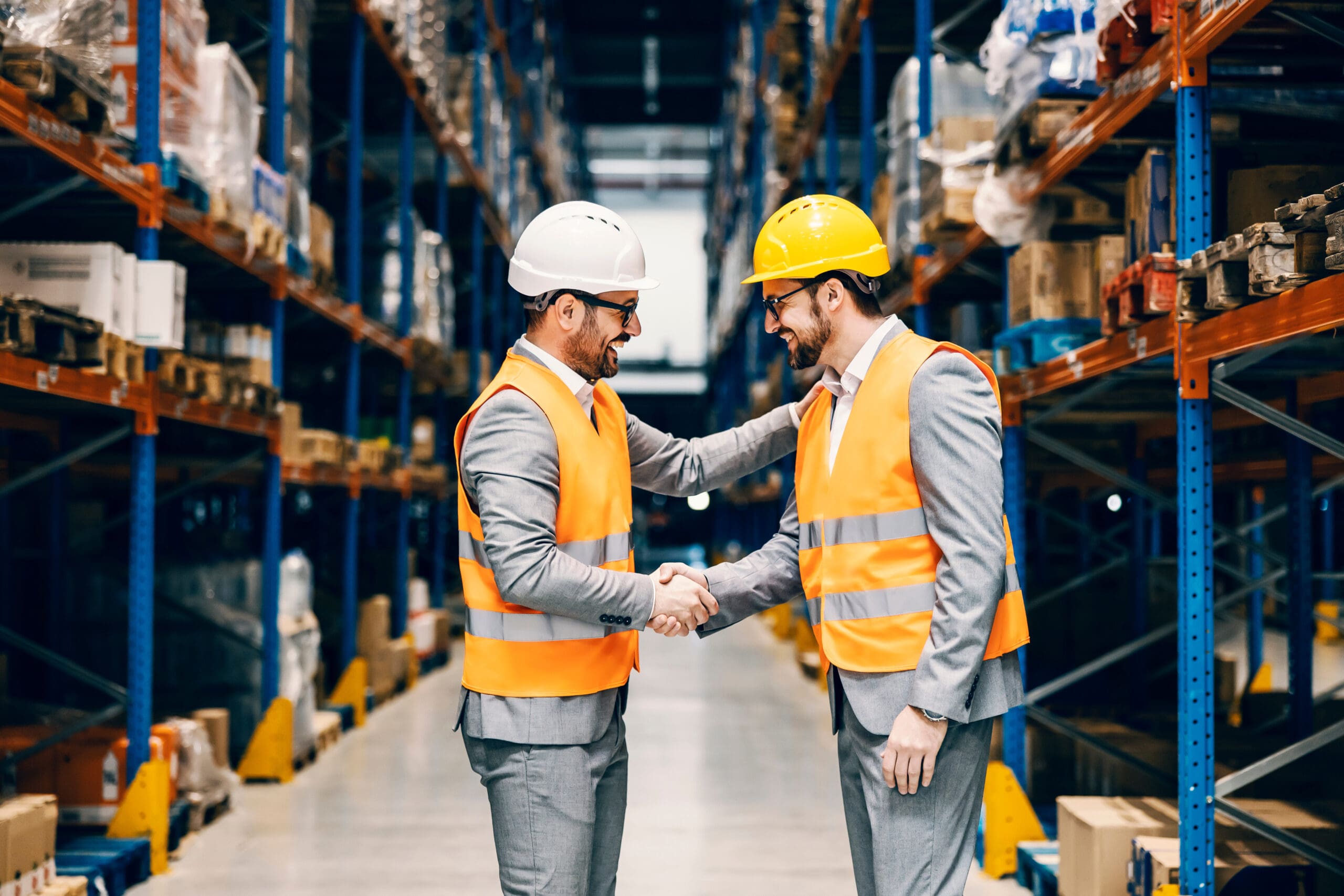 Two Businessmen Shaking Hands And Conclude An Agreement At Storage.