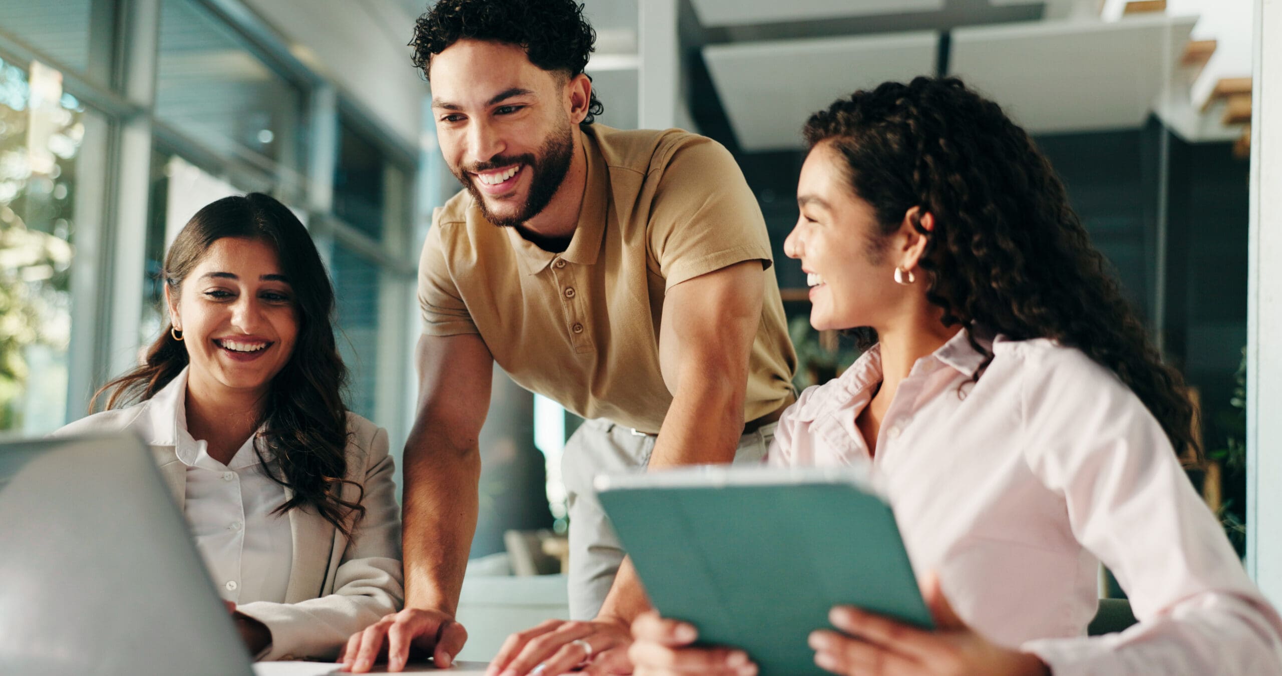 Laughing, Meeting And Colleagues With Tablet, Collaboration And Humor For Project, Group And Office. Happy, Marketing Coordinator And People With Tech For Campaign, Teamwork And Employees With Jokes